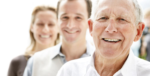 Three people looking out at the camera. An older man, a younger man and a lady